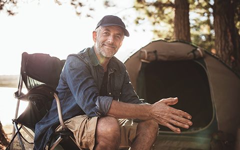 senior man at his campsite